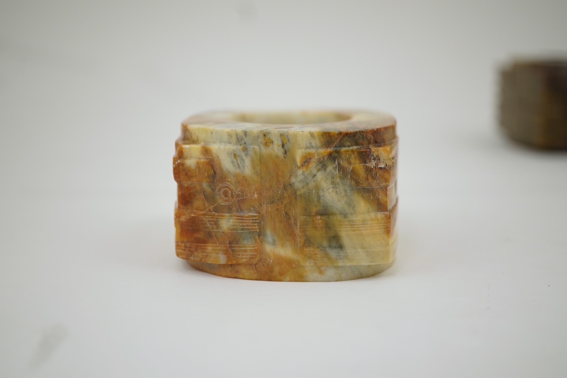 Four Chinese archaistic hardstone or burnt jade cong or cylinders